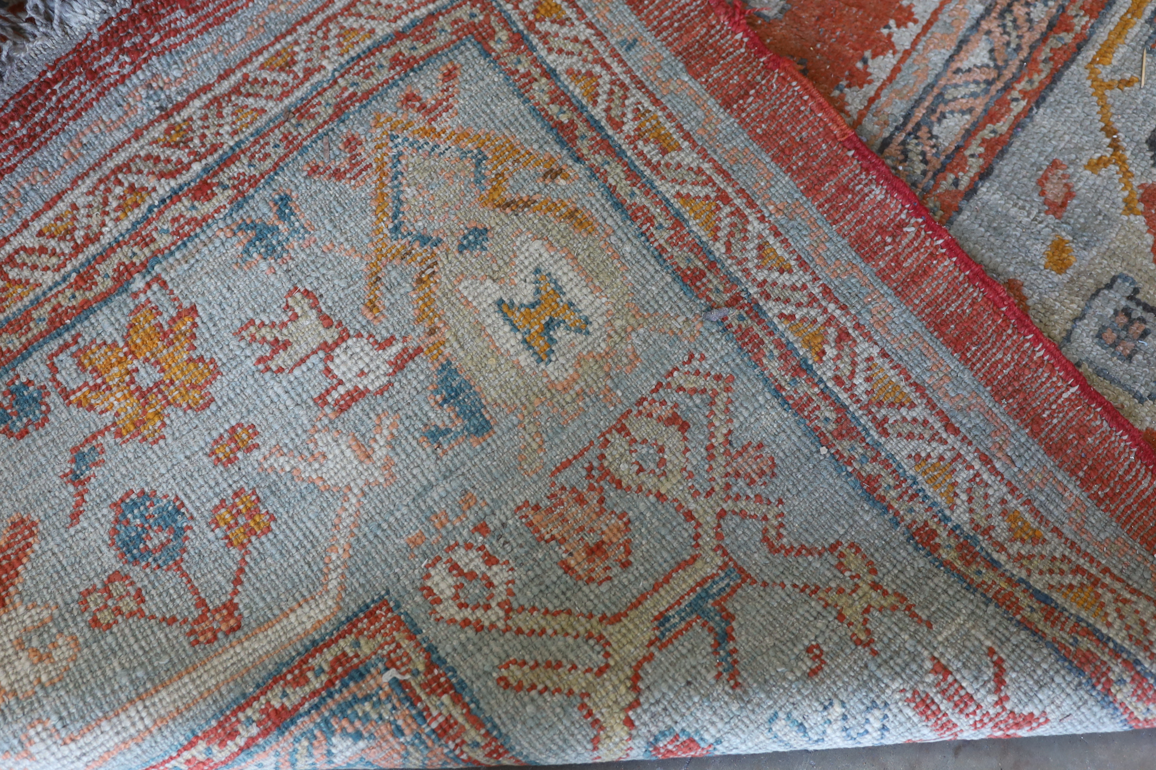 An Afghan red ground carpet, 395 x 310cm